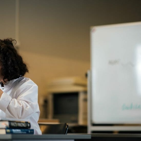 a woman using microscope