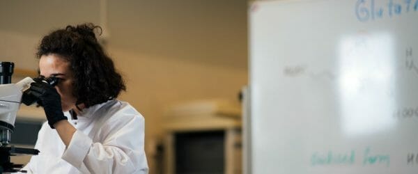 a woman using microscope