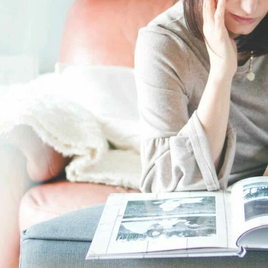 woman looking at photo album