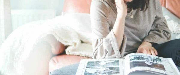 woman looking at photo album