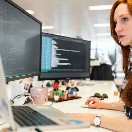 woman coding on computer