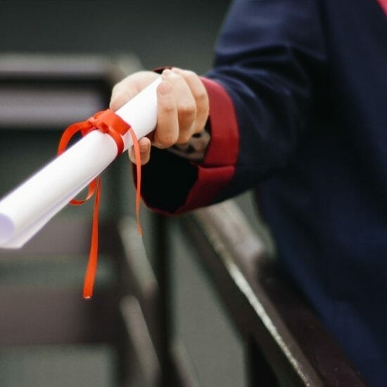 person holding white scroll