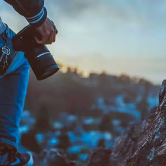 person holding black dslr camera