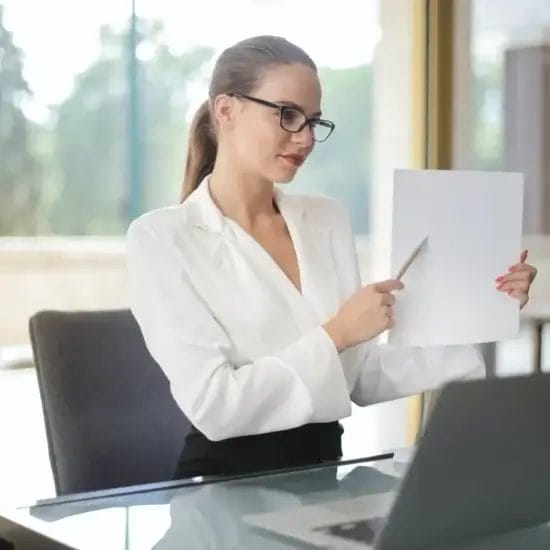 confident businesswoman sharing information from documents in workplace