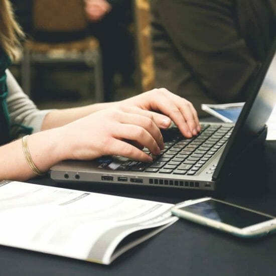 woman typing on laptop