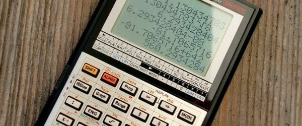 scientific calculator on wooden surface