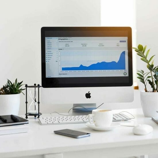 silver imac displaying line graph placed on desk