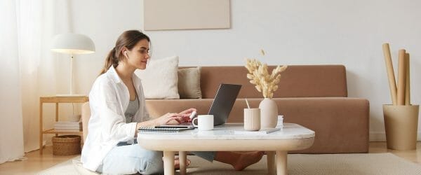 content woman using laptop on floor