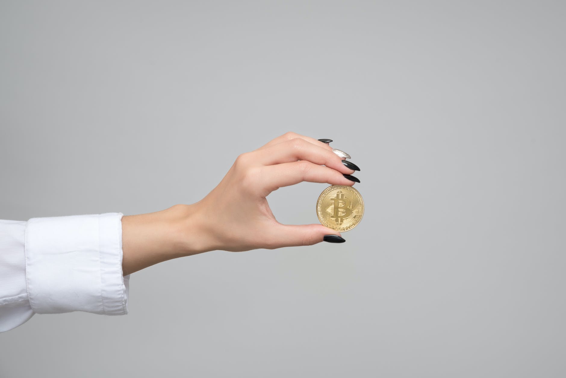 woman holding a bitcoin