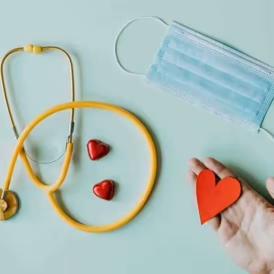 medical stethoscope and mask composed with red foiled chocolate hearts