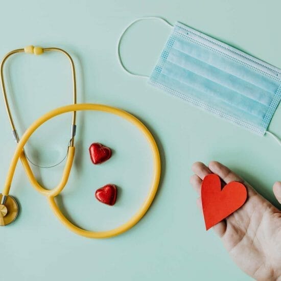 medical stethoscope and mask composed with red foiled chocolate hearts