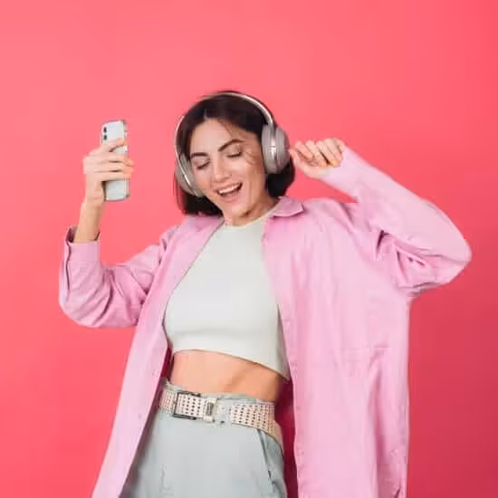 happy positive woman headphones pink red wall