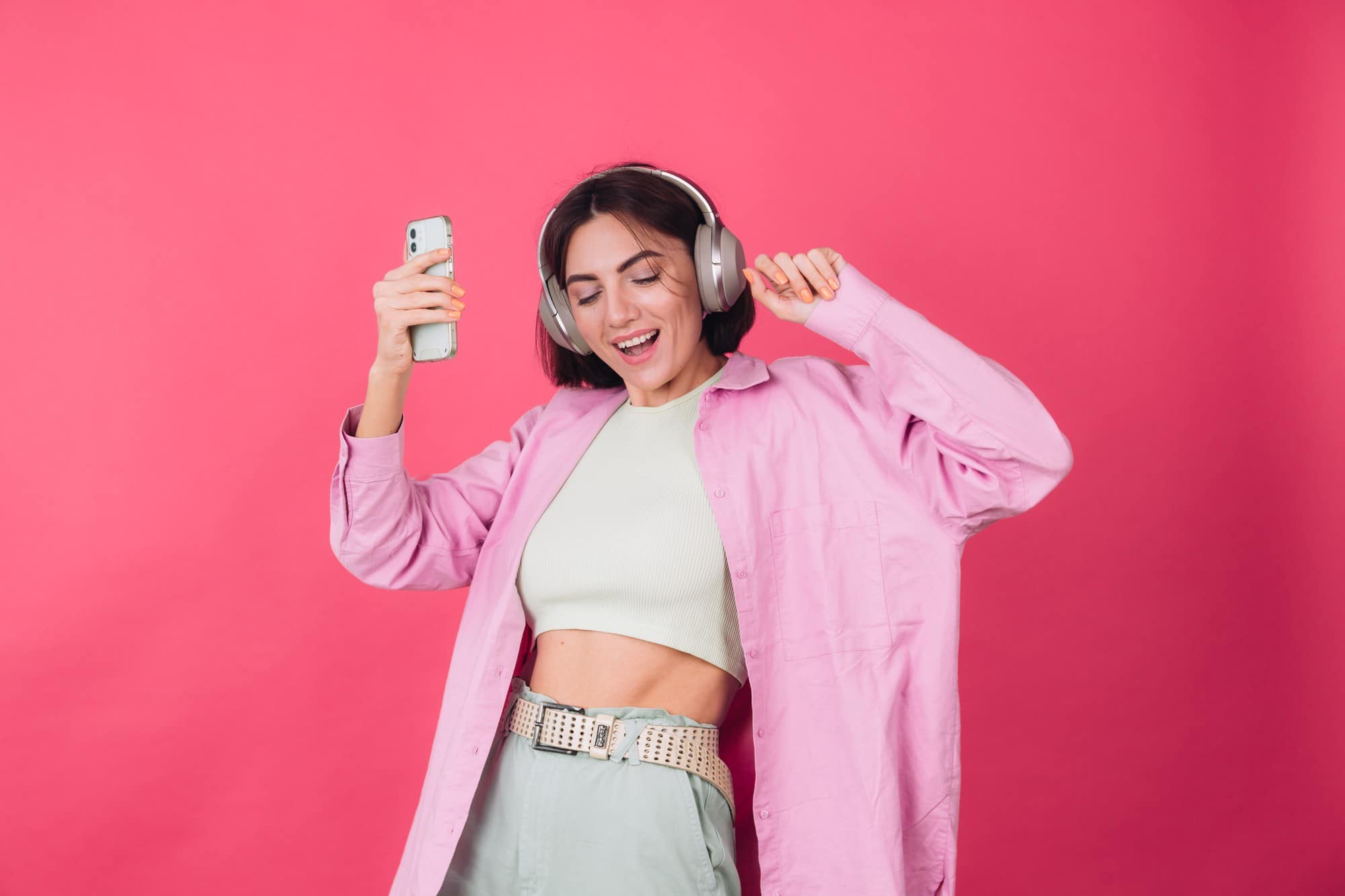 happy positive woman headphones pink red wall