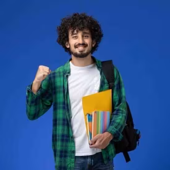front view male student wearing black backpack holding copybooks files blue wall