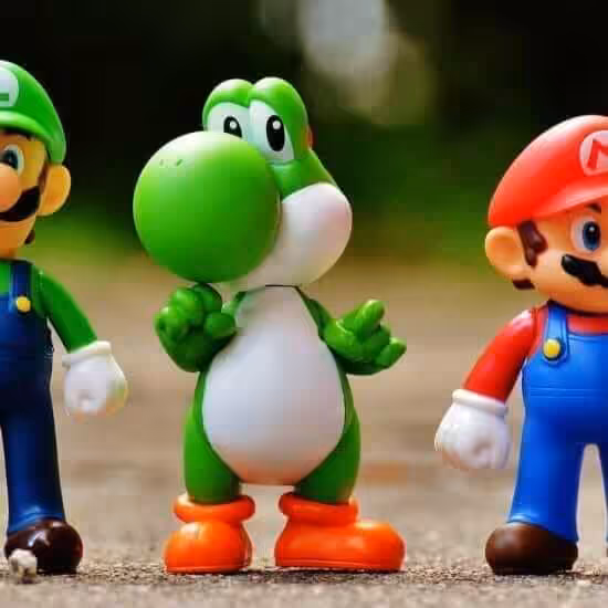 focus photo of super mario luigi and yoshi figurines