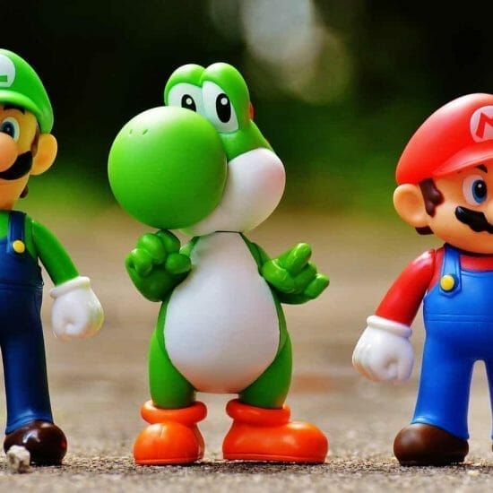 focus photo of super mario luigi and yoshi figurines