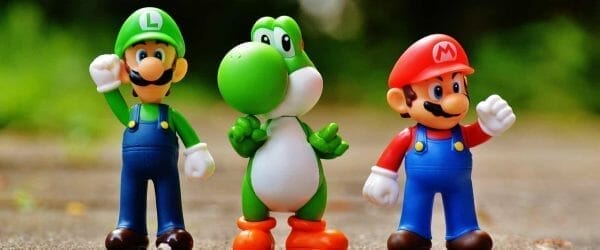 focus photo of super mario luigi and yoshi figurines