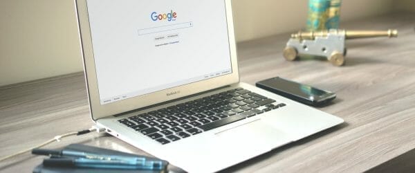 macbook air on grey wooden table