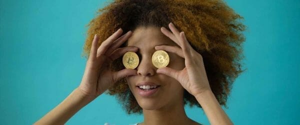 woman holding two coins