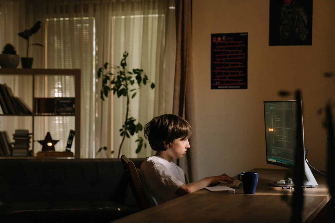 boy in white shirt sitting on chair