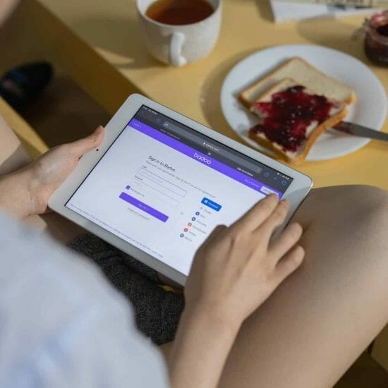 person holding ipad on table