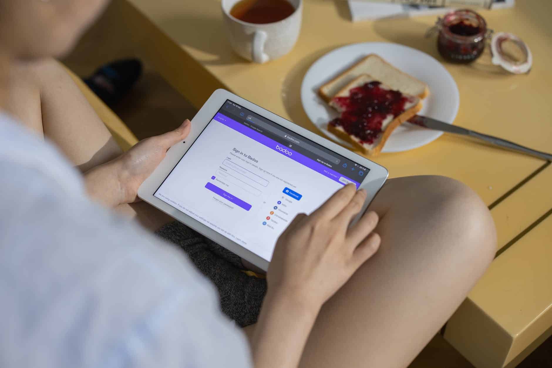 person holding ipad on table