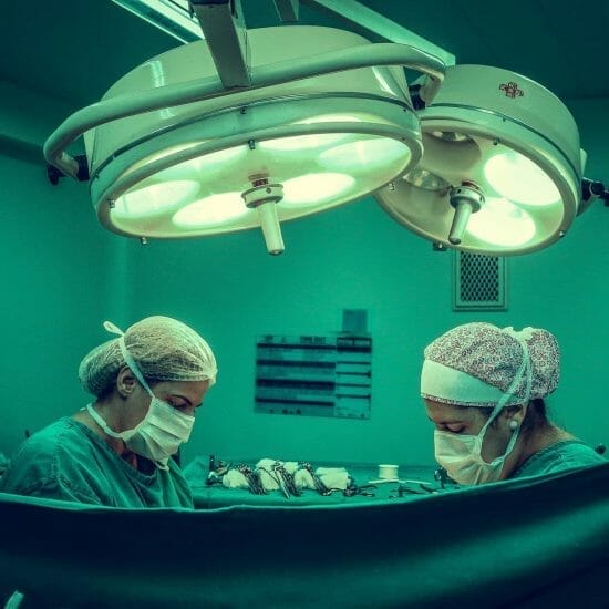 two person doing surgery inside room