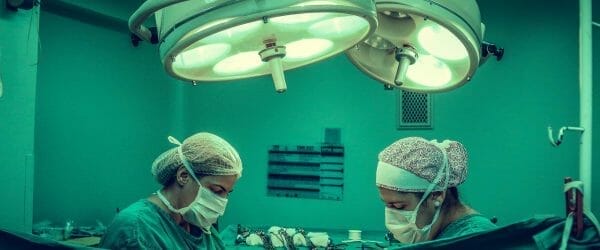 two person doing surgery inside room