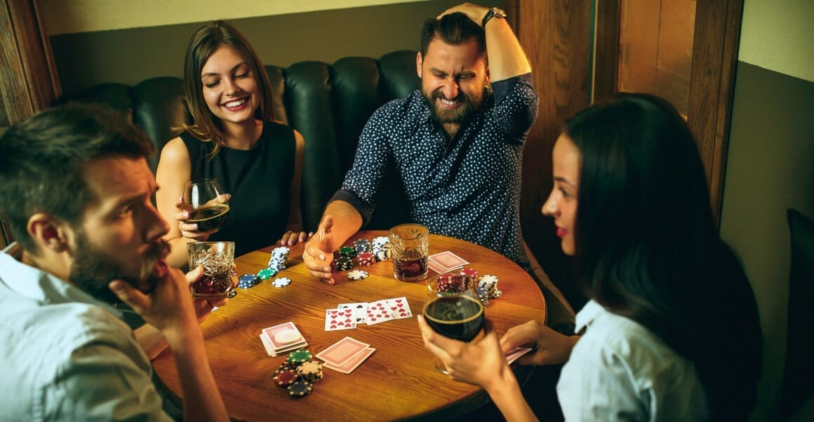 side view photo friends sitting wooden table friends having fun while playing board game 1