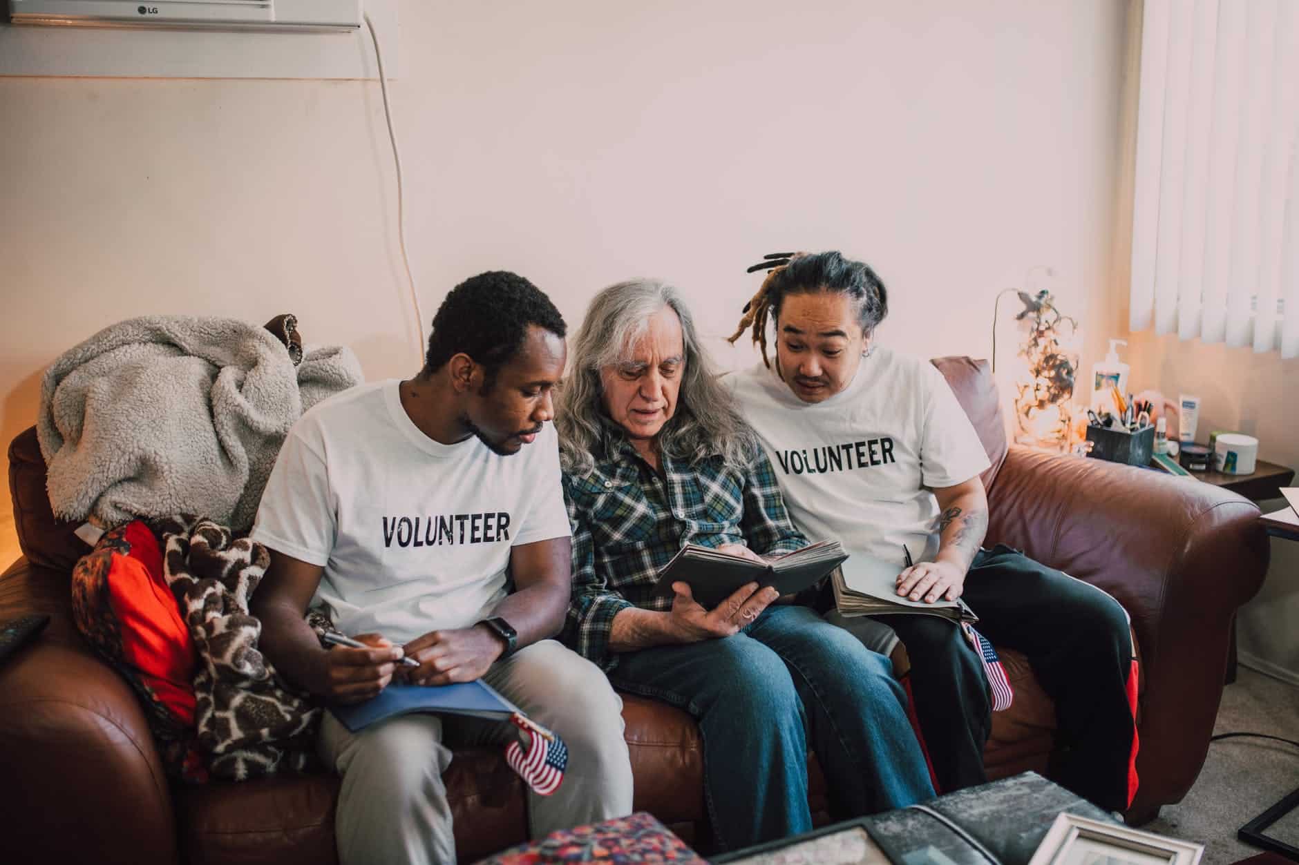 man in white crew neck t shirt sitting beside woman in gray sweater