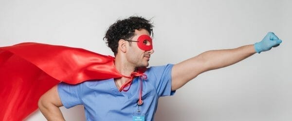 brave doctor in flying superhero cape with fist stretched