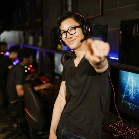 man in black shirt wearing black headphones while smiling