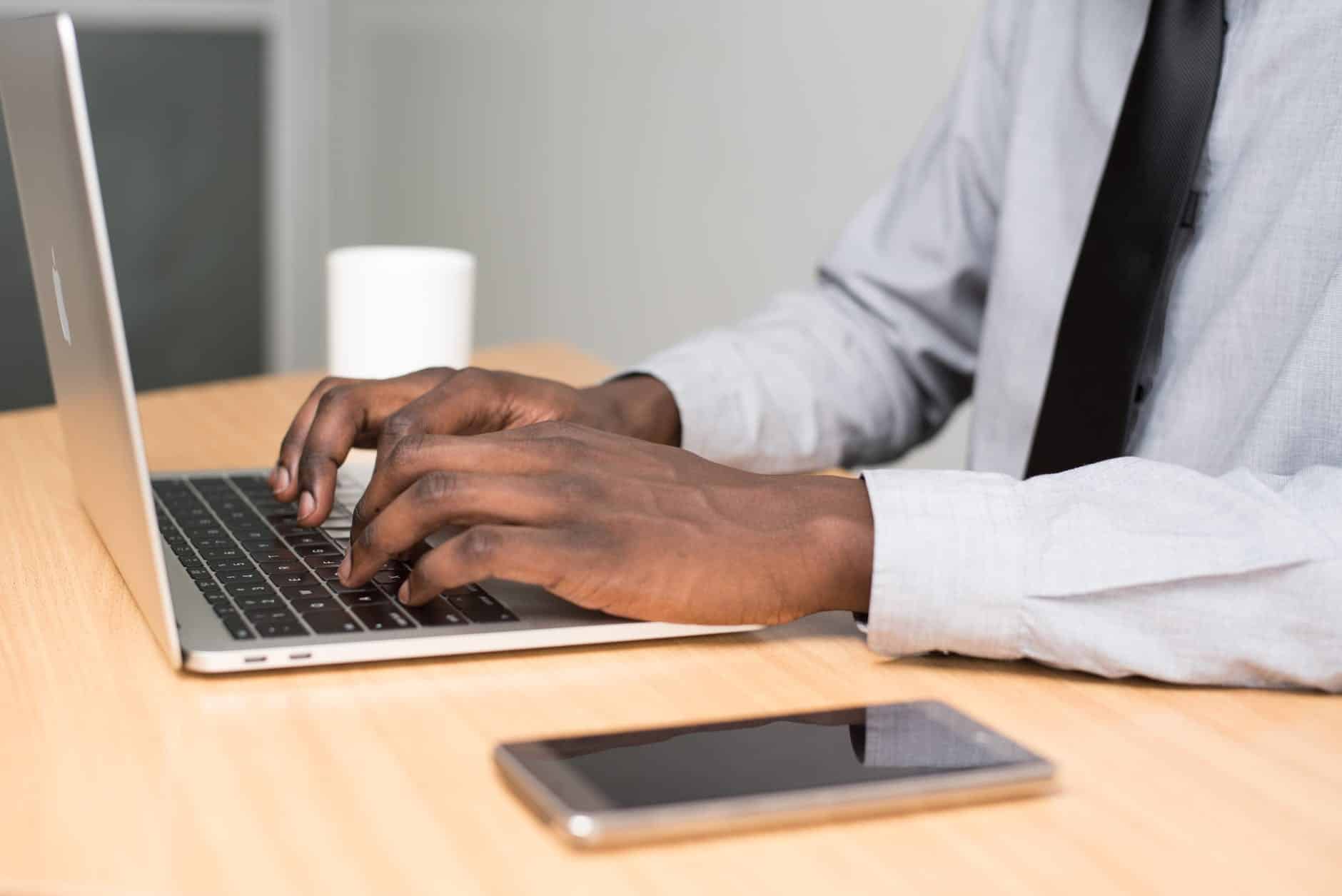 person wearing white dress doing email writing