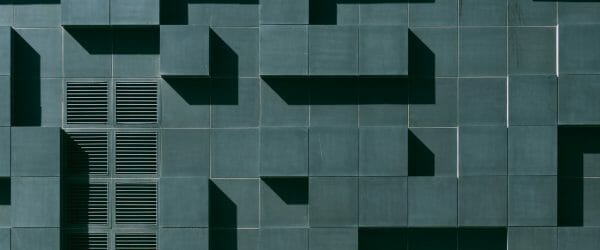 gray concrete building exterior with geometric design