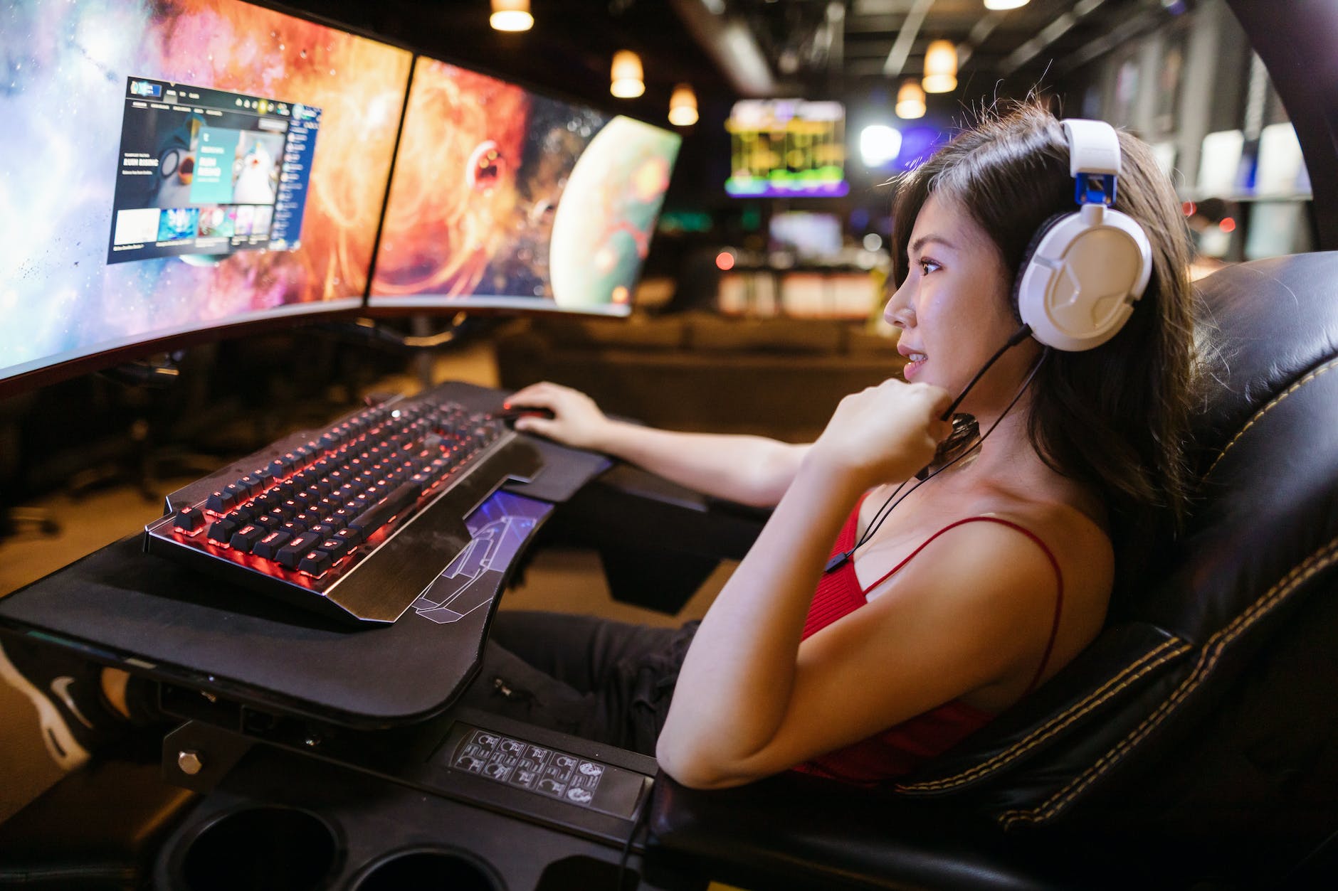 a woman playing video game on a gaming chair