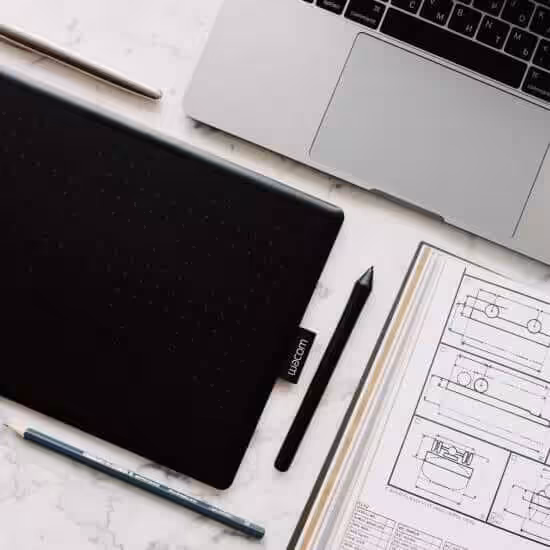 black and silver macbook pro beside black pen