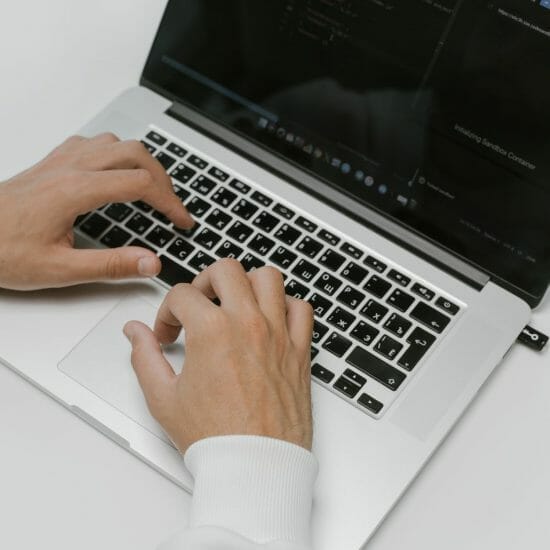 hands on a laptop keyboard