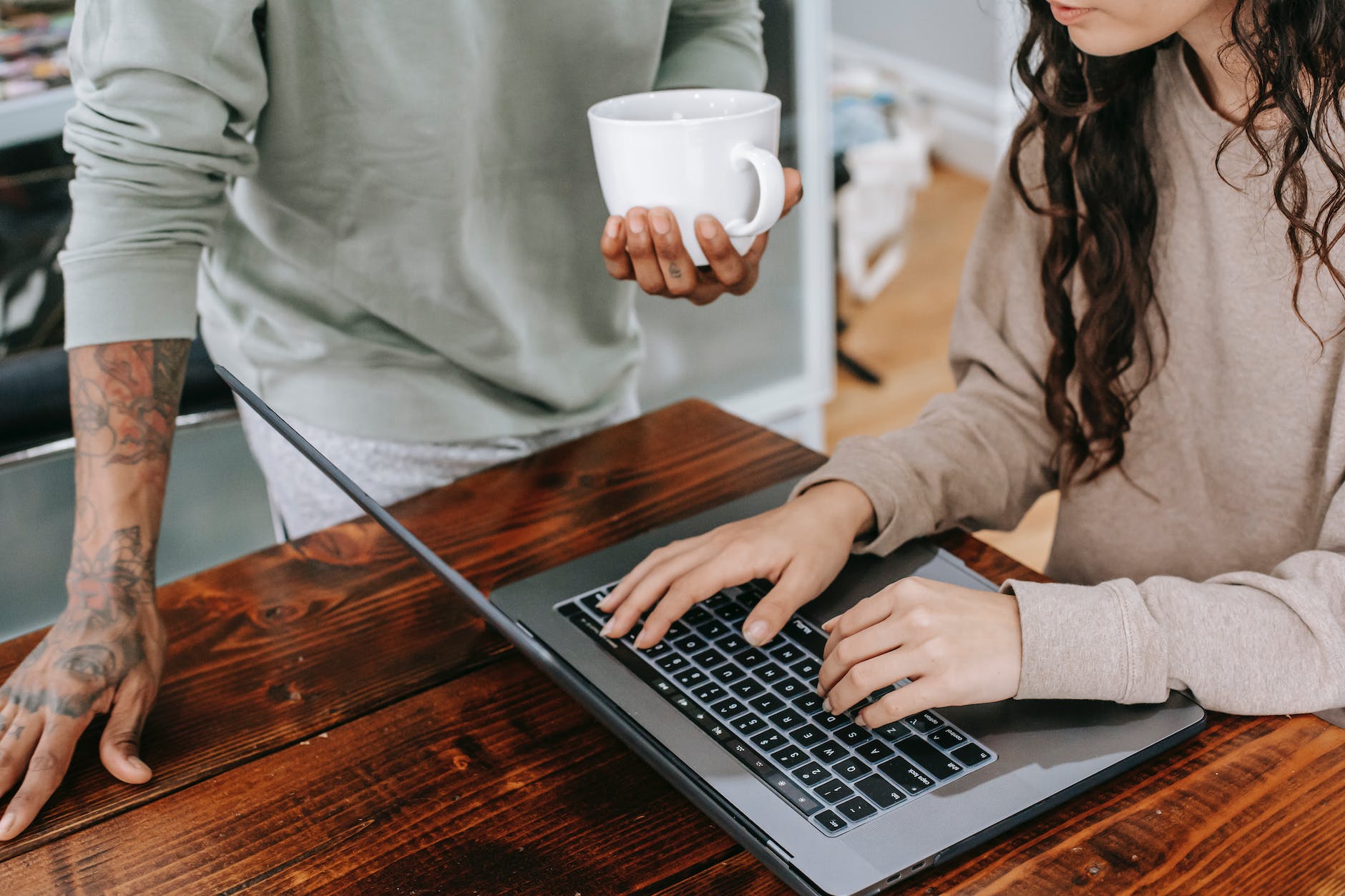 woman in brown long sleeve shirt using macbook pro possibly reading personal finance blogs