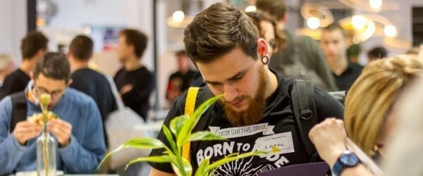 men wearing black shirt holding a purple book