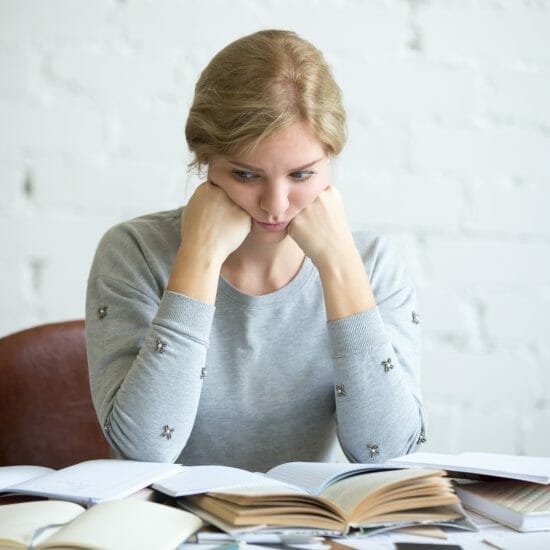 portrait tired student woman desk