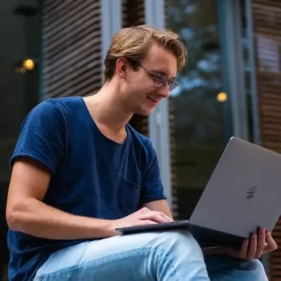 selective focus photo of man using laptop