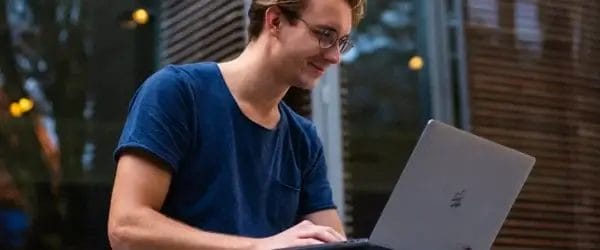 selective focus photo of man using laptop