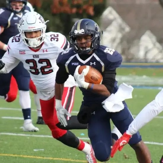 football player carrying brown football