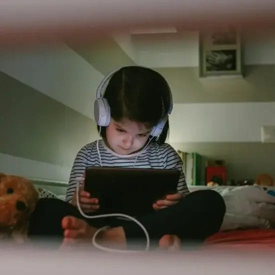 girl with headphones looking tablet