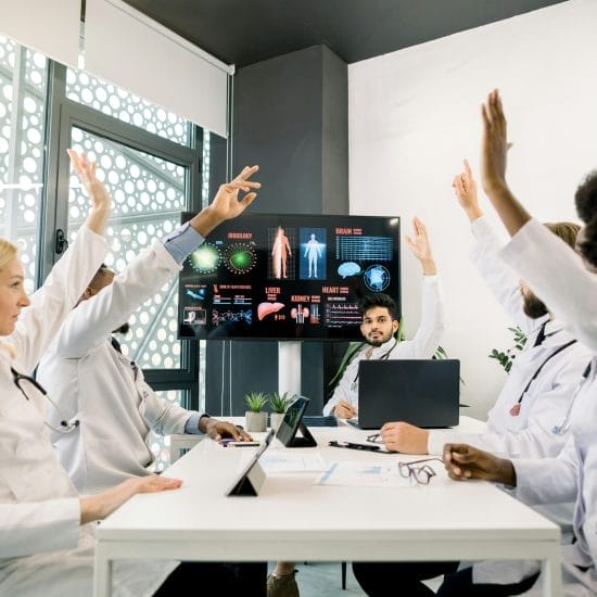 a group of doctors in a meeting showing the The Role of Conferencing Technology in Modern Healthcare