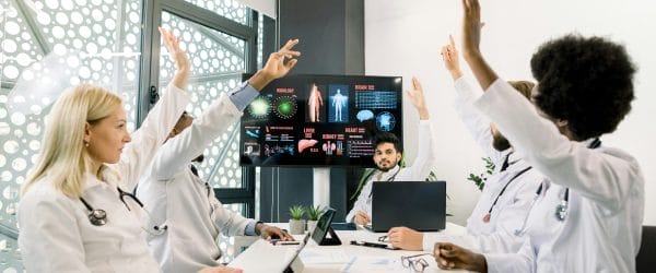 a group of doctors in a meeting showing the The Role of Conferencing Technology in Modern Healthcare