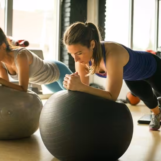 a group of women working out on exercise balls