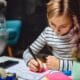 girl writing on sticky notes