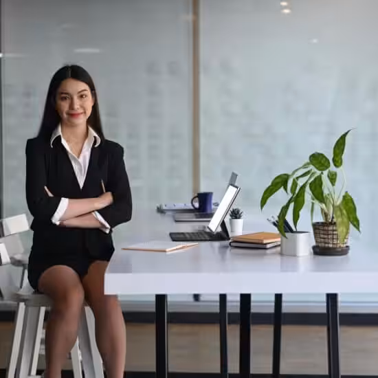 Businesswoman sitting confidently at desk.