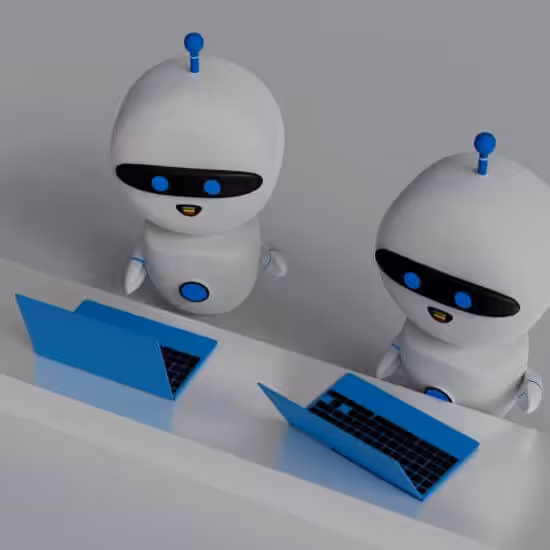 Two robots working on laptops